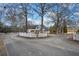 Charming home featuring a circular driveway, white picket fence and mature trees at H-5422 Hill Sw Rd, Powder Springs, GA 30127