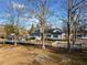 Charming white two-story home with a welcoming front porch, complemented by mature trees at H-5422 Hill Sw Rd, Powder Springs, GA 30127