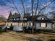A stately white home is framed by bare trees, boasting a full front porch and multiple windows at H-5422 Hill Sw Rd, Powder Springs, GA 30127