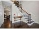 Elegant foyer with hardwood floors, staircase, and view into the living room at H-5422 Hill Sw Rd, Powder Springs, GA 30127