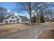 An expansive white home with black shutters and a well manicured front lawn at H-5422 Hill Sw Rd, Powder Springs, GA 30127