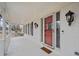 Charming front porch featuring a red door, white brick, and elegant lighting at H-5422 Hill Sw Rd, Powder Springs, GA 30127