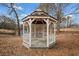 Hexagonal gazebo featuring detailed woodwork and a charming design, set in a natural landscape at H-5422 Hill Sw Rd, Powder Springs, GA 30127