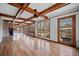 Spacious living room with hardwood floors, wood beams, large windows, and access to the backyard at H-5422 Hill Sw Rd, Powder Springs, GA 30127