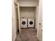 Convenient laundry room featuring modern washer and dryer units and ample storage space at 3568 Eagle Sw Ct, Atlanta, GA 30331