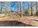 Large backyard surrounded by mature trees, offering plenty of space and privacy at 6218 Creekford Ln, Lithonia, GA 30058