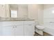 Bright bathroom featuring a vanity with granite counters, white cabinets, and a mirror at 6218 Creekford Ln, Lithonia, GA 30058