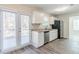 A modern kitchen with stone countertops, stainless appliances, shaker cabinets and access to a patio via french doors at 6218 Creekford Ln, Lithonia, GA 30058