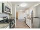 Bright kitchen featuring stainless steel appliances, granite countertops, and modern white cabinetry at 6218 Creekford Ln, Lithonia, GA 30058