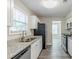 Bright kitchen featuring granite countertops and modern appliances at 6218 Creekford Ln, Lithonia, GA 30058