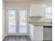 Modern kitchenette featuring stainless appliances, stone countertops, and access to a patio via french doors at 6218 Creekford Ln, Lithonia, GA 30058