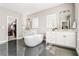 Bright bathroom featuring dual sinks, a soaking tub, and a walk-in closet at 6669 Encore Blvd, Atlanta, GA 30328