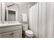 Clean bathroom featuring a white vanity, toilet, and shower with a white curtain at 6669 Encore Blvd, Atlanta, GA 30328