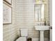 Stylish powder room boasts designer wallpaper, pedestal sink, and elegant mirror at 6669 Encore Blvd, Atlanta, GA 30328