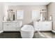 Bathroom featuring dual sink vanities and a soaking tub with natural light from two windows at 6669 Encore Blvd, Atlanta, GA 30328