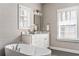 Bright bathroom featuring a soaking tub and white cabinets at 6669 Encore Blvd, Atlanta, GA 30328