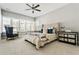 Bright bedroom featuring tufted headboard, ceiling fan, and oversized windows at 6669 Encore Blvd, Atlanta, GA 30328