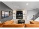 A cozy living room with a black marble fireplace, custom shelving, and comfortable orange lounge seating at 6669 Encore Blvd, Atlanta, GA 30328