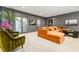 A spacious living room with large orange sectional, decorative plants, and access to a patio at 6669 Encore Blvd, Atlanta, GA 30328