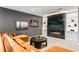 Living room with a cozy black marble fireplace, custom shelving, and comfortable orange sectional seating at 6669 Encore Blvd, Atlanta, GA 30328