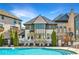 Relaxing pool scene showcasing pristine pool water, lounge chairs, attractive landscaping, and a luxury home exterior at 6669 Encore Blvd, Atlanta, GA 30328