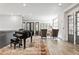 Relaxing sitting area with grand piano, wood floors, neutral walls, and ample natural lighting at 6669 Encore Blvd, Atlanta, GA 30328