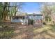 Backyard view featuring a screened porch, small set of steps, and partial brick foundation at 772 Verde Dr, Riverdale, GA 30274