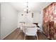 Well-lit dining area with modern chandelier and floor-to-ceiling floral curtains at 772 Verde Dr, Riverdale, GA 30274