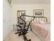 Bedroom featuring an exercise machine and a bed with pink patterned bedding at 806 Lismore Se, Smyrna, GA 30080