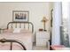 Bedroom features a bed with pink patterned bedding, side table, and window at 806 Lismore Se, Smyrna, GA 30080