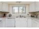 Bright kitchen with white appliances and sink overlooking backyard at 806 Lismore Se, Smyrna, GA 30080