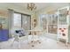 Cozy sun room featuring wicker furniture, bright light, and a charming chandelier at 806 Lismore Se, Smyrna, GA 30080