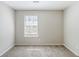 A bedroom featuring neutral walls, carpet, and a window at 2419 Leslie Brook Dr, Decatur, GA 30035