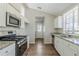 Modern kitchen with stainless steel appliances, granite countertops, and white cabinets at 2419 Leslie Brook Dr, Decatur, GA 30035