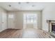 Bright living room boasts wood floors, a bay window, and a cozy stone fireplace at 2419 Leslie Brook Dr, Decatur, GA 30035