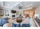 This cozy living room has coffered ceilings, a fireplace, built in cabinets and access to the kitchen and stairs at 405 Grafton Walk, Woodstock, GA 30188