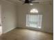 Large bedroom with wood-look floors, ceiling fan and natural light from window at 5611 Executive Way, Norcross, GA 30071
