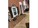 Charming brick townhome with black shutters and meticulously landscaped front yard at 5611 Executive Way, Norcross, GA 30071