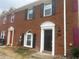 Charming brick townhouse with a black door, arched window, and black shutters at 5611 Executive Way, Norcross, GA 30071