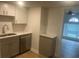 Efficient kitchen features white cabinets, modern sink and new stainless steel dishwasher at 5611 Executive Way, Norcross, GA 30071