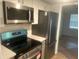 Well-equipped kitchen with stainless steel appliances, including microwave, stove, and refrigerator at 5611 Executive Way, Norcross, GA 30071