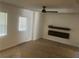 Relaxing living room features wood-look floors, electric fireplace and ceiling fan at 5611 Executive Way, Norcross, GA 30071
