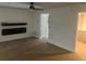 Open living room features wood-look floors, electric fireplace and modern ceiling fan at 5611 Executive Way, Norcross, GA 30071