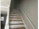 Stairway with white risers and light wood-look treads, complemented by a white handrail and trim at 5611 Executive Way, Norcross, GA 30071