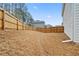 Large backyard featuring a wooden fence and dry grass at 114 Green Tree Ct, Dacula, GA 30019