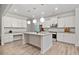 Well-lit kitchen showcasing white cabinetry, a center island with seating, and modern stainless steel appliances at 114 Green Tree Ct, Dacula, GA 30019