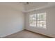 A carpeted bedroom with a large window offering natural light and neighborhood views at 2724 Kristen Ct, Conyers, GA 30012