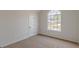 Bedroom featuring carpeted floors, a window, and a door at 2724 Kristen Ct, Conyers, GA 30012