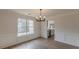 Dining room featuring chair rail with a view to the kitchen and large window at 2724 Kristen Ct, Conyers, GA 30012