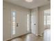 Bright foyer featuring hardwood floors, sidelights, and a classic white front door at 2724 Kristen Ct, Conyers, GA 30012